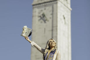 ashley santos posing in front of campanile for graduation photoshoot